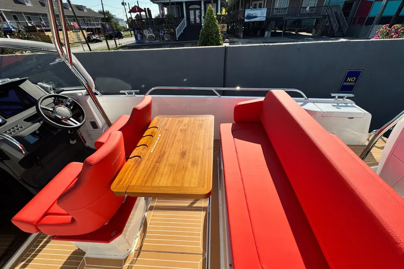 Slide: The Image of Red seating and wooden table on 2025 Nimbus Tender 8 boat deck. - 30