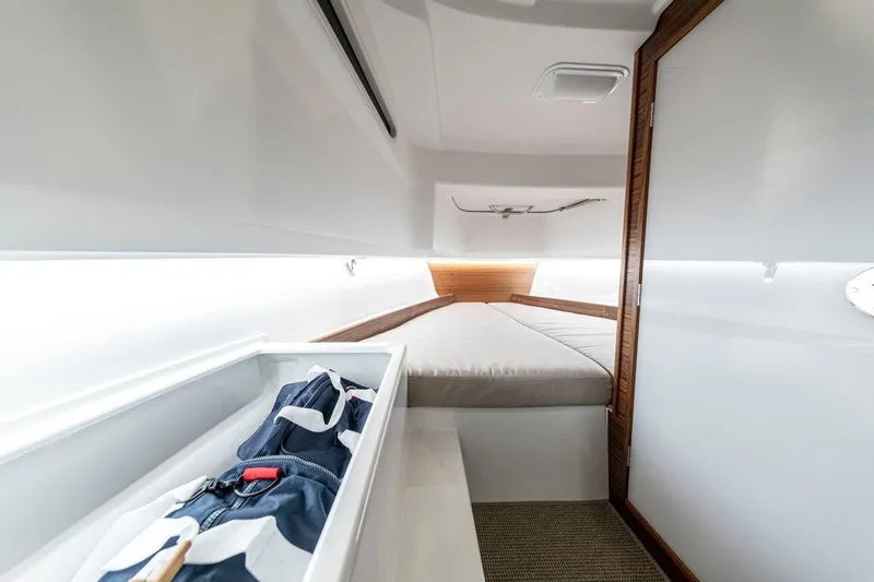 Slide: The Image of 2025 Nimbus Tender 8 cabin interior with bed and storage compartment. - 35