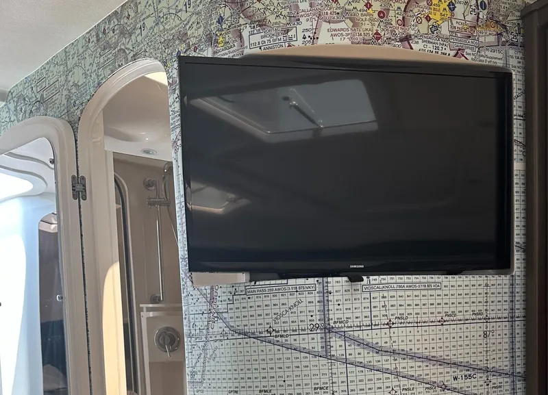 Slide: The Image of Flat-screen TV on Intrepid 475 Sport Yacht 2020, with nautical chart wallpaper background. - 12