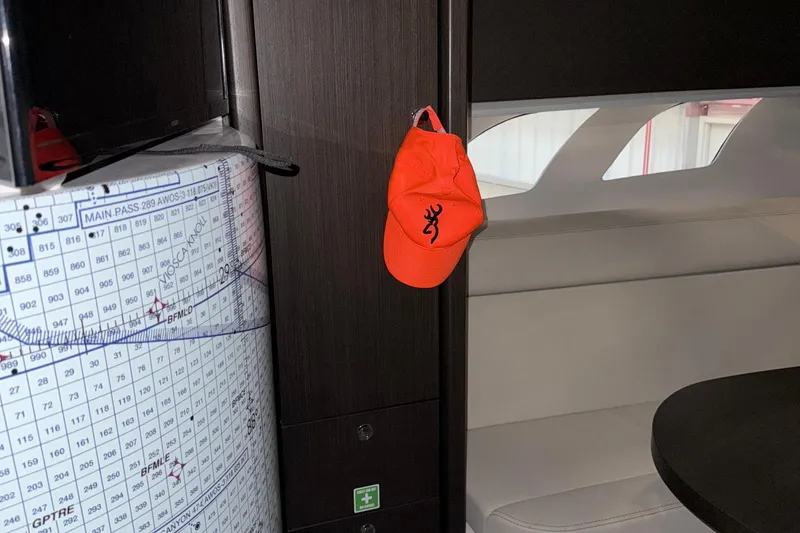 Slide: The Image of Interior of 2020 Intrepid 475 Sport Yacht with orange cap and nautical chart. - 16