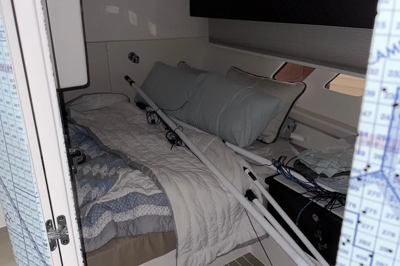 Slide: The Image of Cozy cabin interior of 2020 Intrepid 475 Sport Yacht with bed and nautical equipment. - 18