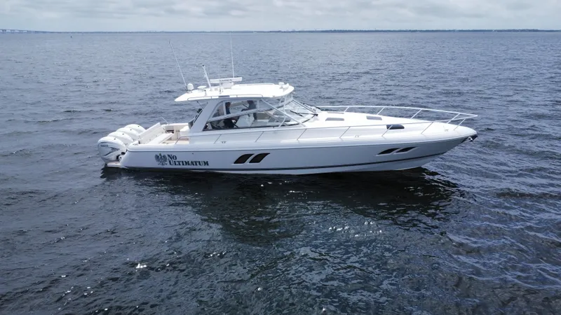 Slide: The Image of 2020 Intrepid 475 Sport Yacht cruising on open water. - 2