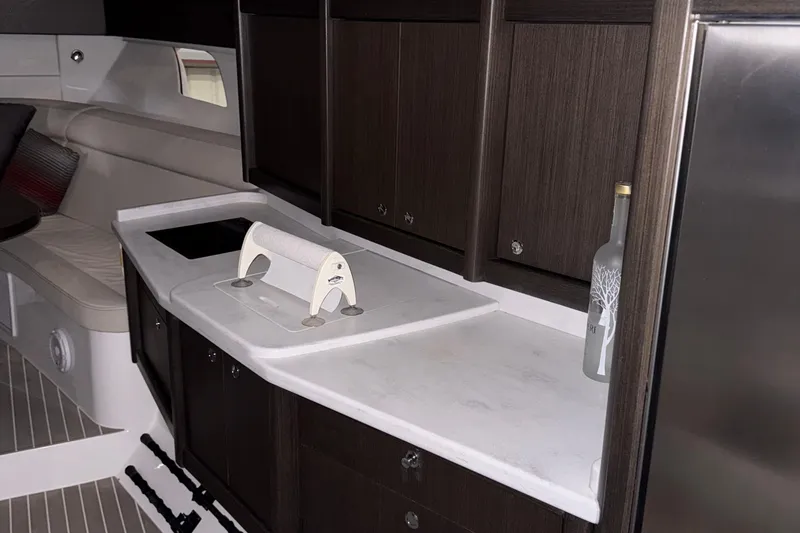 Slide: The Image of Luxurious interior of 2020 Intrepid 475 Sport Yacht with modern kitchenette and seating area. - 20