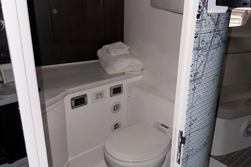 Slide: The Image of 2020 Intrepid 475 Sport Yacht bathroom with modern fixtures and folded towels. - 21