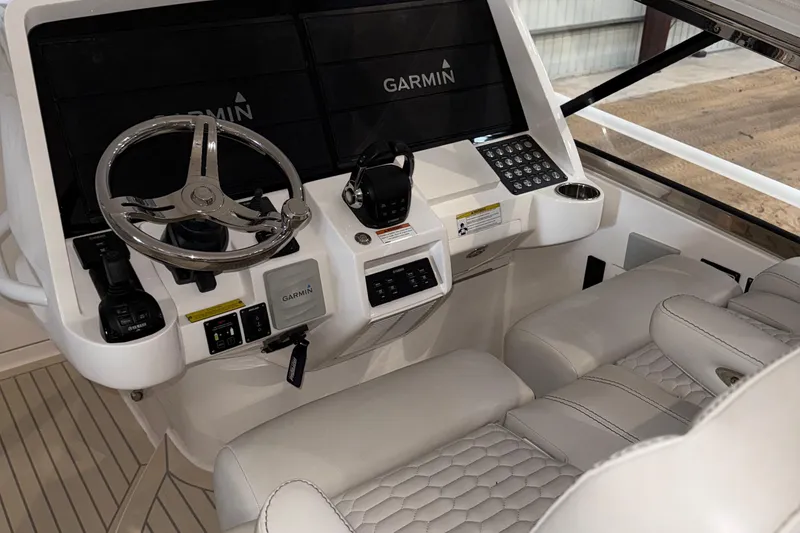 Slide: The Image of 2020 Intrepid 475 Sport Yacht helm with Garmin navigation and luxurious seating. - 27
