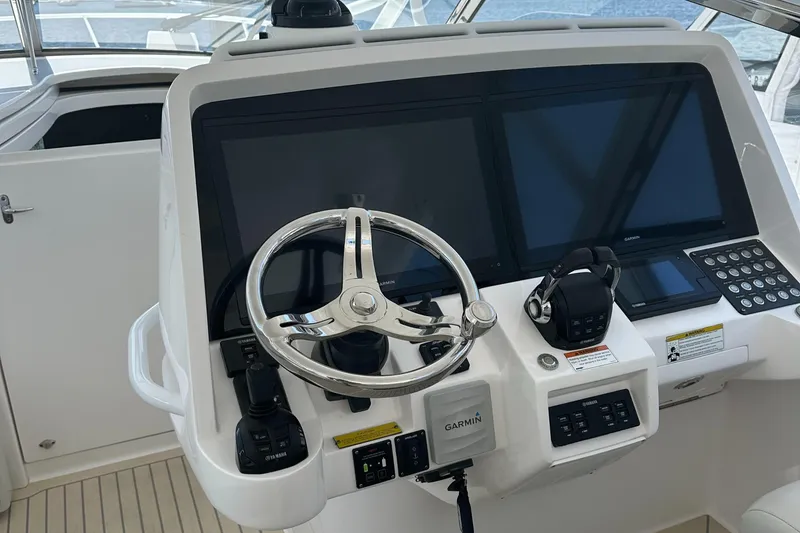 Slide: The Image of Helm of 2020 Intrepid 475 Sport Yacht with Garmin displays and steering wheel. - 9