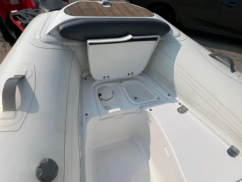Slide: The Image of 2017 Walker Bay Generation 360 DLX boat interior with storage compartment open. - 10