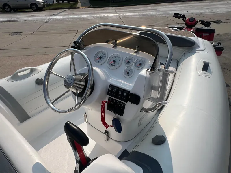 Slide: The Image of 2017 Walker Bay Generation 360 DLX boat dashboard with steering wheel and control panel. - 6