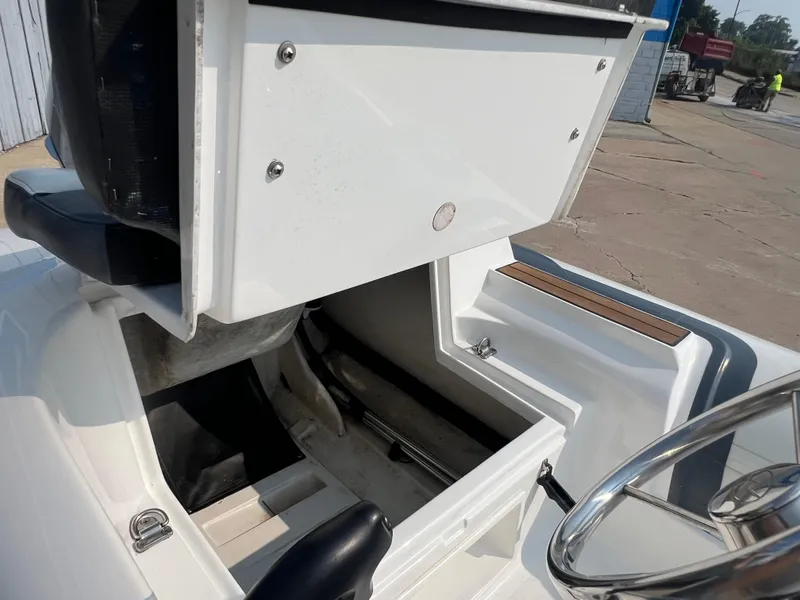 Slide: The Image of 2017 Walker Bay Generation 360 DLX boat interior storage compartment and steering wheel. - 8