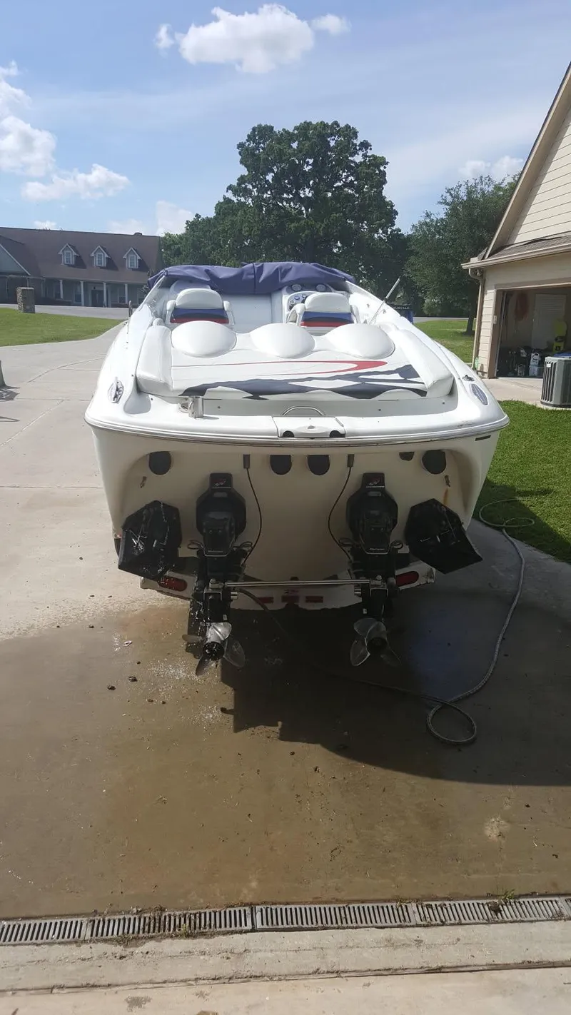 Slide: The Image of 2001 Baja 342 boat on driveway, dual engines, sunny day, residential background. - 3
