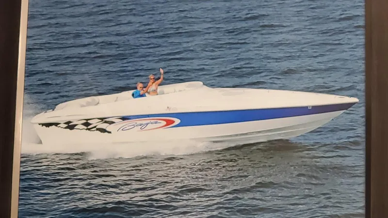 Slide: The Image of 2001 Baja 342 speedboat cruising on open water with passengers waving. - 9