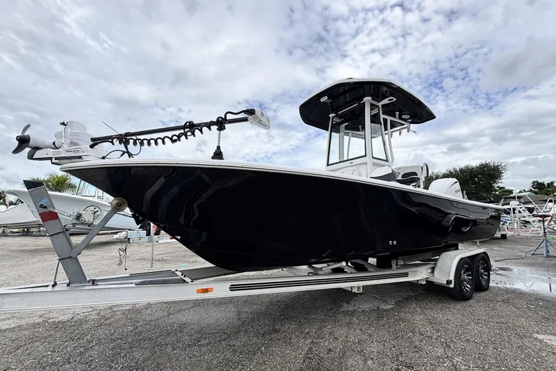 The Image of 2026 Tidewater 2300 Carolina Bay boat on trailer under cloudy sky. - 0