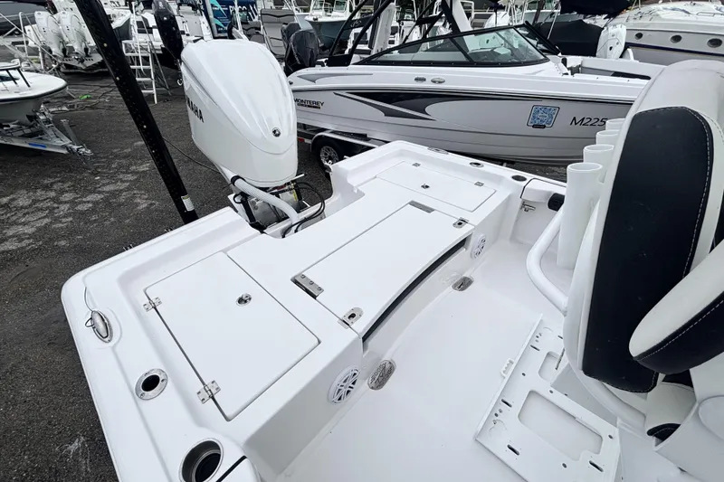 Slide: The Image of 2026 Tidewater 2300 Carolina Bay boat with Yamaha engine, docked among other boats. - 12