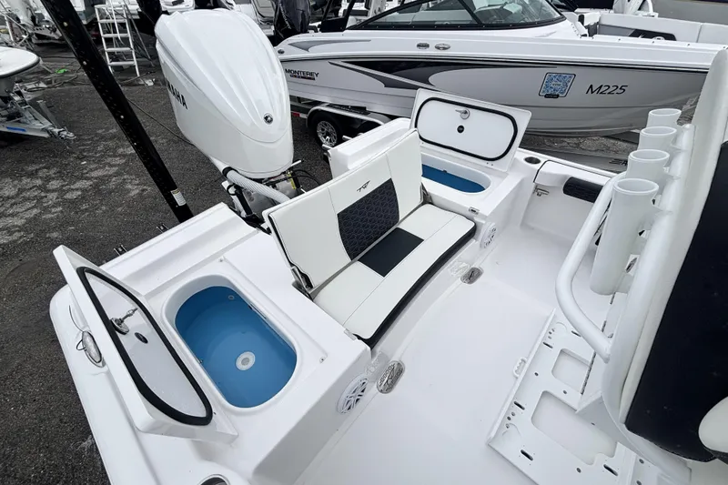 Slide: The Image of 2026 Tidewater 2300 Carolina Bay boat interior with seating, storage, and Yamaha engine. - 13