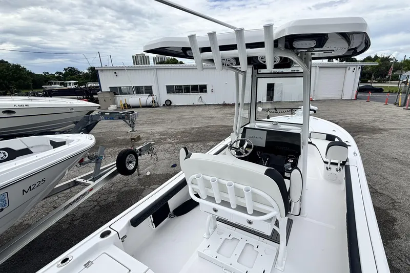 Slide: The Image of 2026 Tidewater 2300 Carolina Bay boat with T-top and Garmin electronics, parked outdoors. - 17