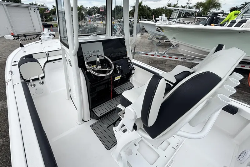 Slide: The Image of 2026 Tidewater 2300 Carolina Bay boat interior with Garmin navigation system and seating. - 18