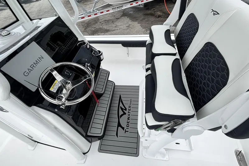Slide: The Image of 2026 Tidewater 2300 Carolina Bay boat interior with Garmin system and stylish seating. - 19