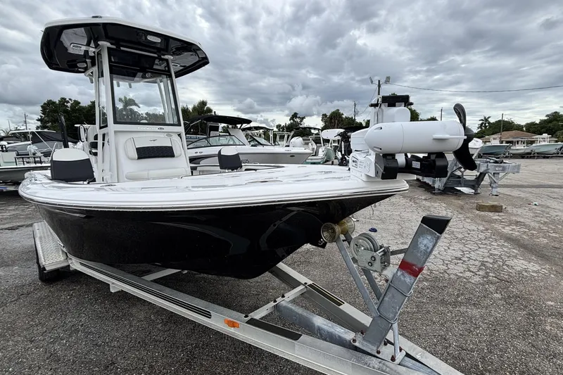 Slide: The Image of 2026 Tidewater 2300 Carolina Bay boat on trailer under cloudy sky. - 2