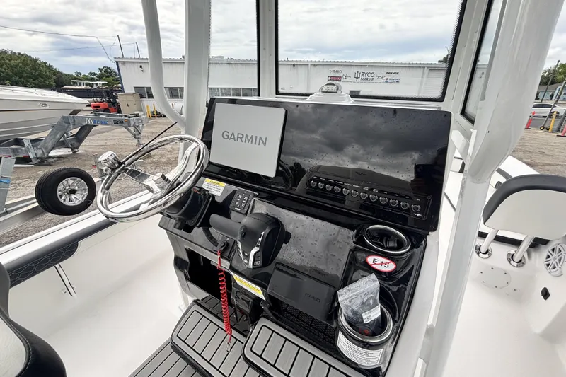 Slide: The Image of 2026 Tidewater 2300 Carolina Bay boat console with Garmin display and steering wheel. - 21