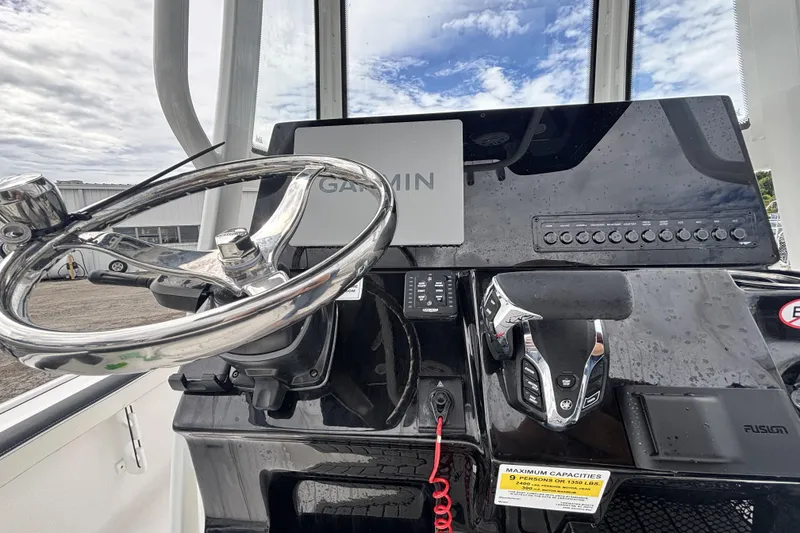 Slide: The Image of 2026 Tidewater 2300 Carolina Bay boat dashboard with Garmin navigation and steering wheel. - 22