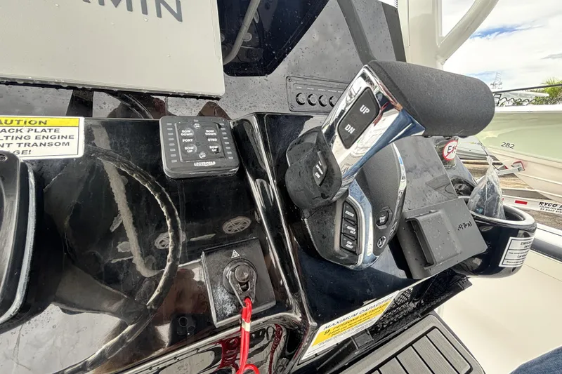 Slide: The Image of Control panel of 2026 Tidewater 2300 Carolina Bay boat with throttle and navigation equipment. - 23