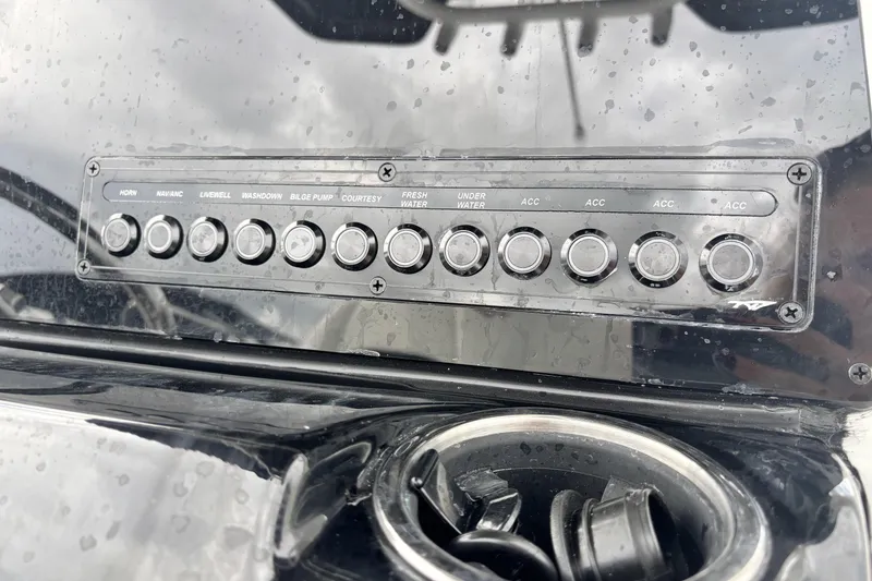 Slide: The Image of Control panel of 2026 Tidewater 2300 Carolina Bay boat with labeled buttons. - 24