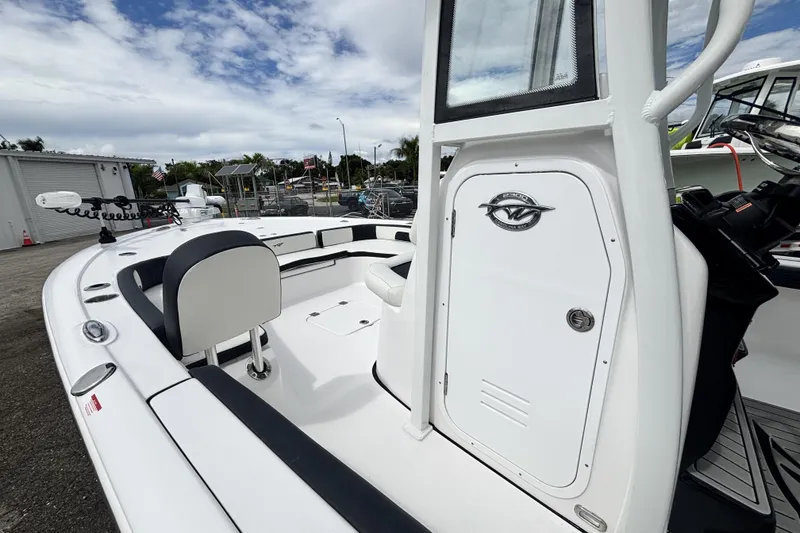Slide: The Image of 2026 Tidewater 2300 Carolina Bay boat interior with seating and console, docked outdoors. - 26
