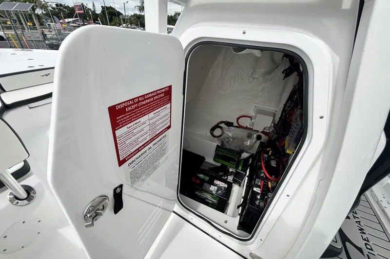 Slide: The Image of Open hatch of 2026 Tidewater 2300 Carolina Bay boat showing battery compartment. - 27