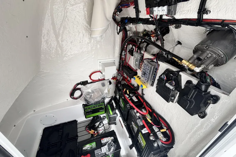 Slide: The Image of Electrical system inside 2026 Tidewater 2300 Carolina Bay boat, featuring batteries and wiring. - 28