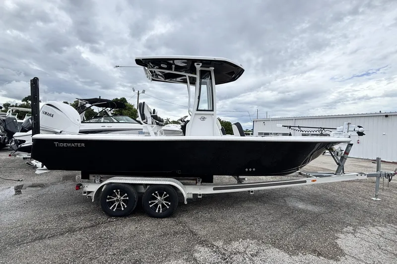 Slide: The Image of 2026 Tidewater 2300 Carolina Bay boat on trailer, black hull, overcast sky. - 3