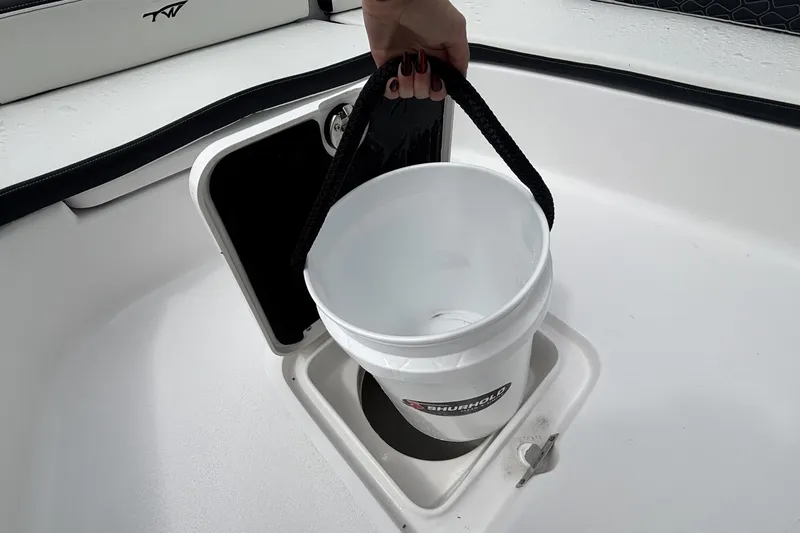 Slide: The Image of White bucket in storage compartment of 2026 Tidewater 2300 Carolina Bay boat. - 30