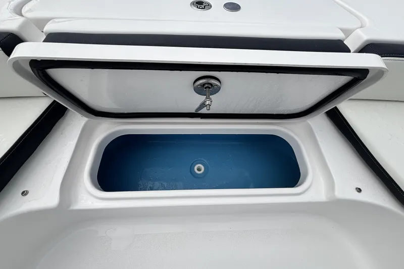 Slide: The Image of Livewell compartment on 2026 Tidewater 2300 Carolina Bay boat, open with blue interior. - 32