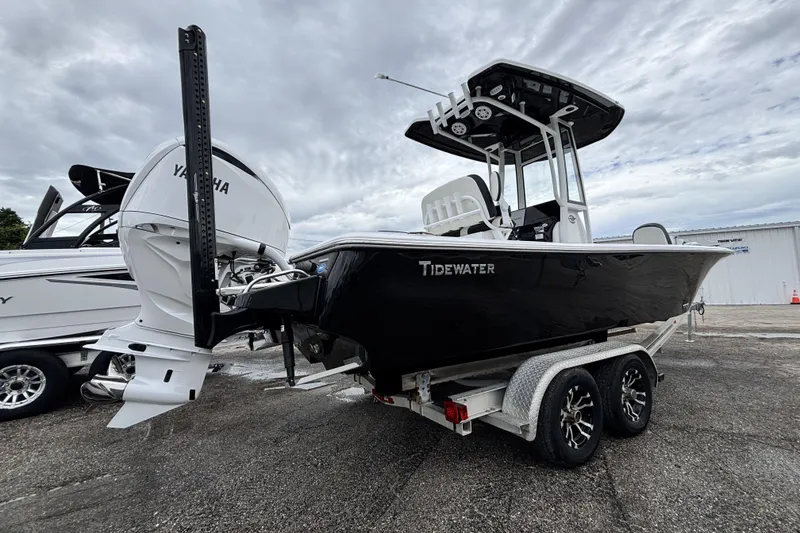 Slide: The Image of 2026 Tidewater 2300 Carolina Bay boat on trailer, featuring Yamaha engine, under cloudy sky. - 4