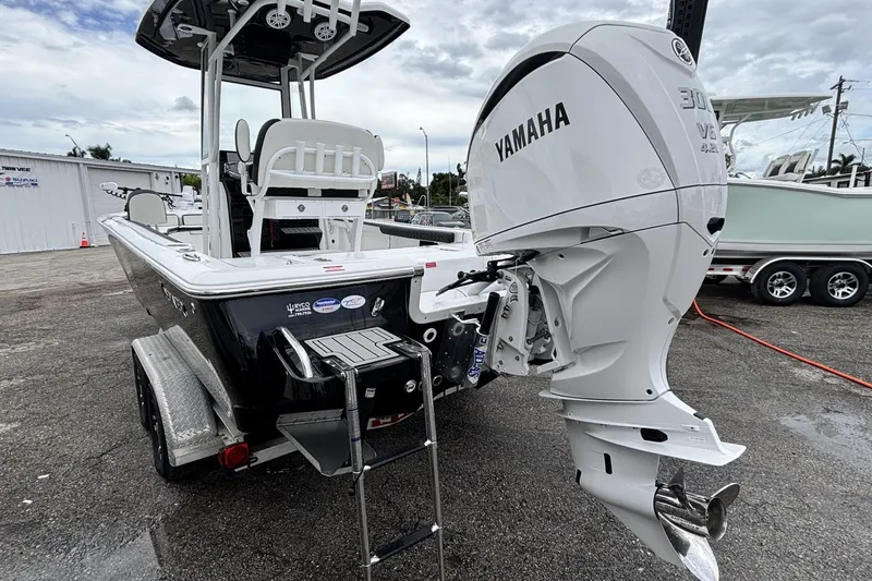 Slide: The Image of 2026 Tidewater 2300 Carolina Bay boat with Yamaha V6 engine, parked on a trailer. - 7