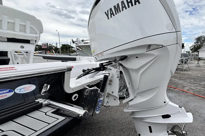 Slide: The Image of 2026 Tidewater 2300 Carolina Bay boat with Yamaha outboard motor, docked outdoors. - 9