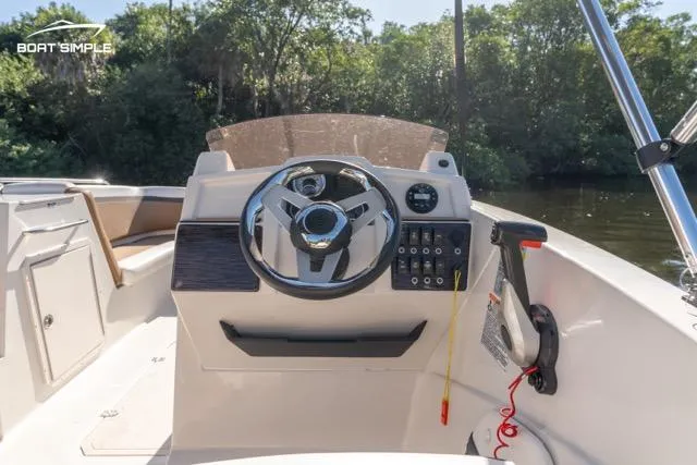 Slide: The Image of 2023 Starcraft SVX 231 OB DH boat dashboard with steering wheel and controls. - 11