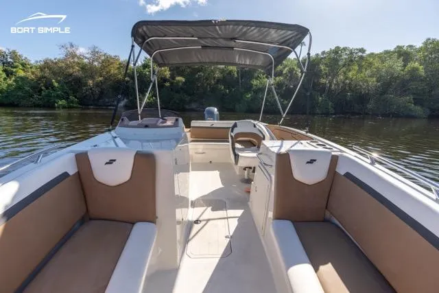 Slide: The Image of 2023 Starcraft SVX 231 OB DH boat interior with canopy on calm river. - 4