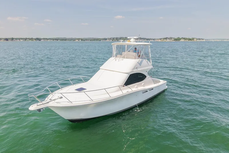 Slide: The Image of 2006 Tiara Yachts 3900 Convertible cruising on calm waters under a clear sky. - 10