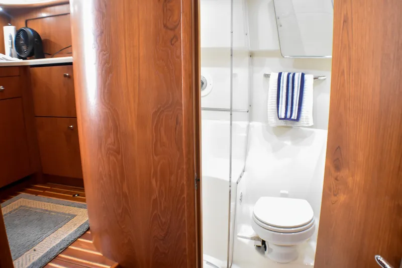 Slide: The Image of 2006 Tiara Yachts 3900 Convertible bathroom with wooden cabinetry and modern fixtures. - 12
