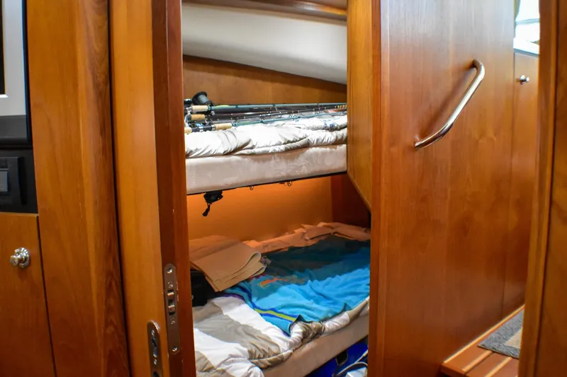 Slide: The Image of Bunk beds in 2006 Tiara Yachts 3900 Convertible cabin with wooden interior. - 14