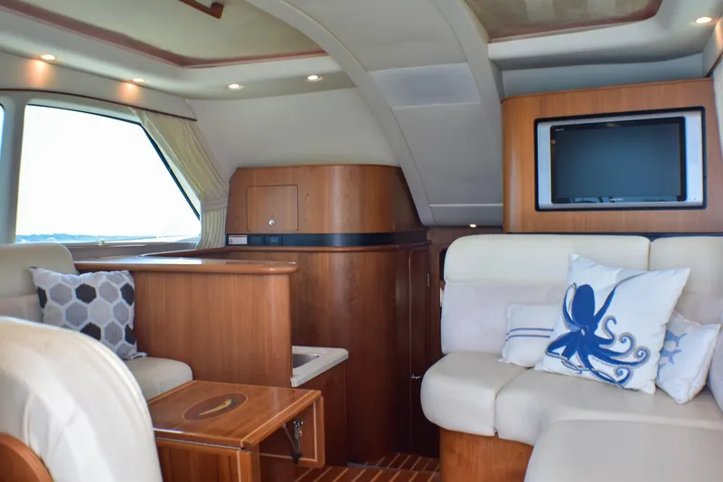 Slide: The Image of Luxurious interior of 2006 Tiara Yachts 3900 Convertible with plush seating and elegant wood finishes. - 16