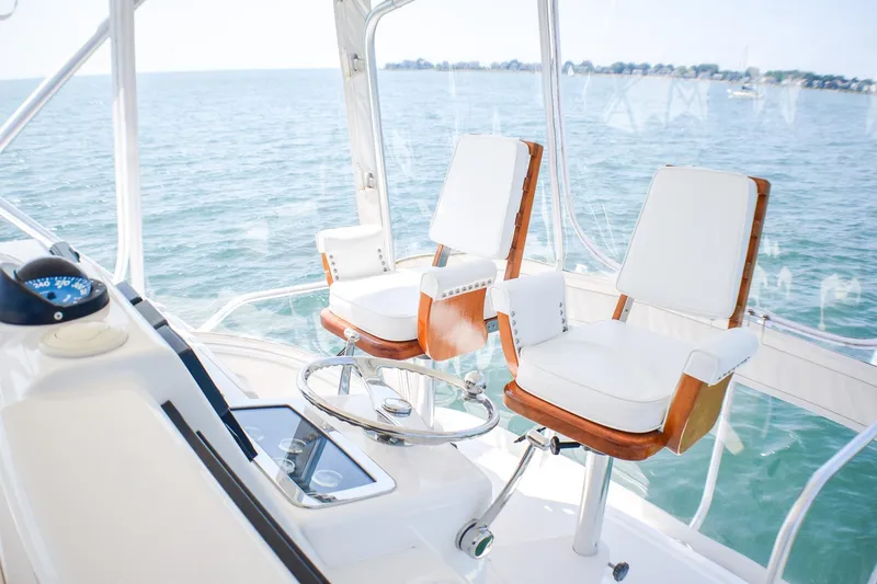 Slide: The Image of Luxury helm chairs on 2006 Tiara Yachts 3900 Convertible, overlooking serene ocean view. - 20