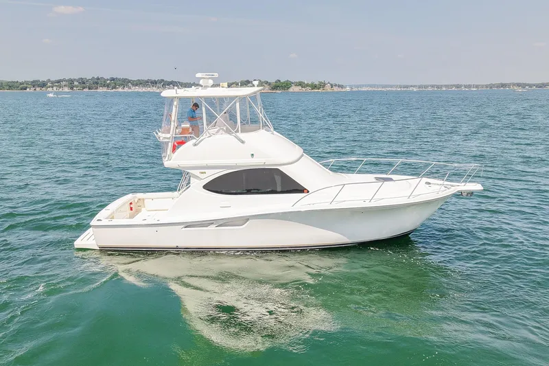 Slide: The Image of 2006 Tiara Yachts 3900 Convertible cruising on open water. - 6