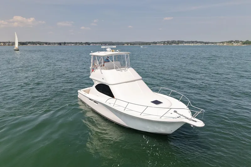 Slide: The Image of 2006 Tiara Yachts 3900 Convertible cruising on a calm, scenic lake. - 7