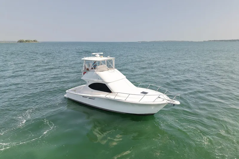 Slide: The Image of 2006 Tiara Yachts 3900 Convertible cruising on open water. - 9