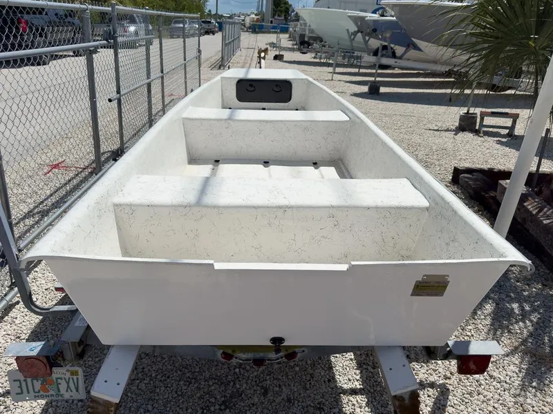 Slide: The Image of 2026 Coastal Skiff 145 boat on trailer in outdoor storage area. - 3