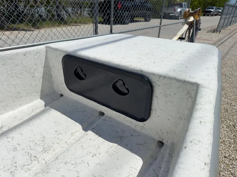 Slide: The Image of 2026 Coastal Skiff 145 boat interior with textured surface and black panel. - 4