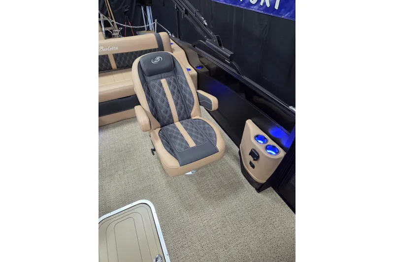 Slide: The Image of 2026 Barletta Lusso 23UC interior with open storage compartment and beige seating. - 9