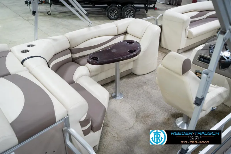 Slide: The Image of 2008 Bennington 20 SL pontoon boat interior with beige seating and a central table. - 14