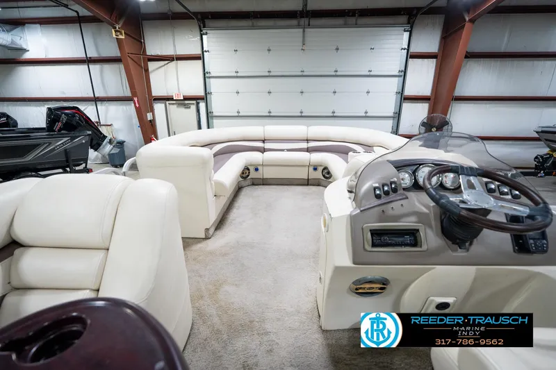 Slide: The Image of Interior of a 2008 Bennington 20 SL pontoon boat with plush seating and control panel. - 18